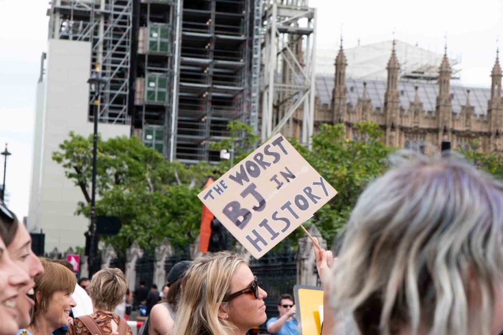 poster mokcing boris johnson. The protest poster says "the worst BJ in history".
